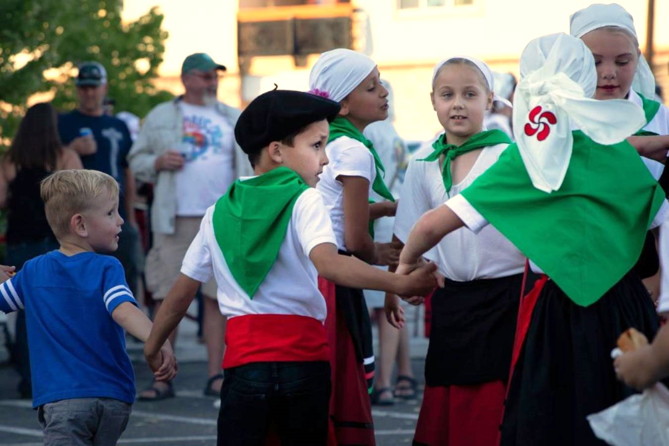 A group of children holding hands outside