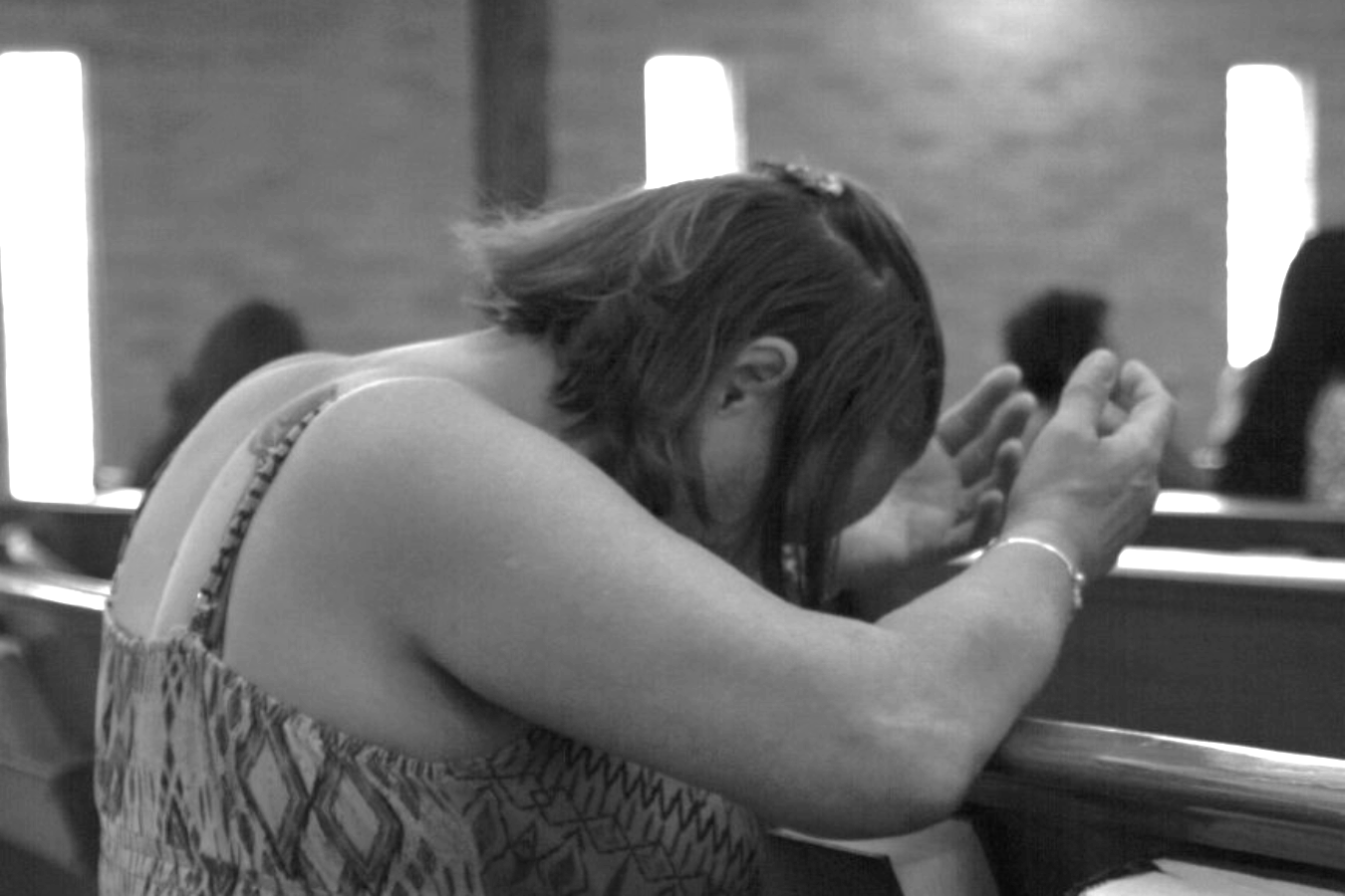 Woman praying in church