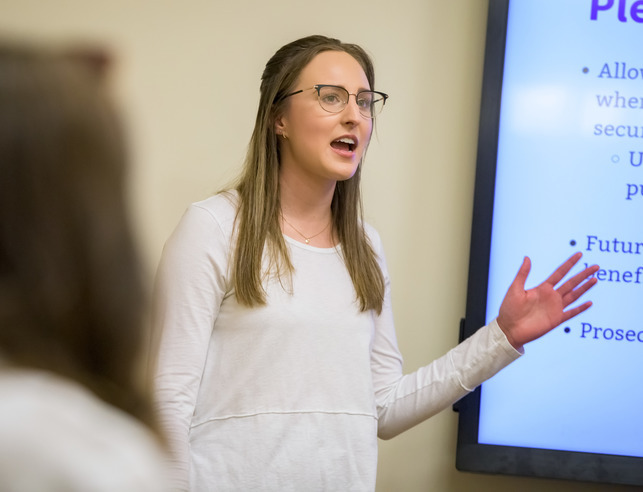 A University of Wyoming student confidently gives a presentation in front of the class