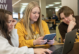 College students in a library study area.