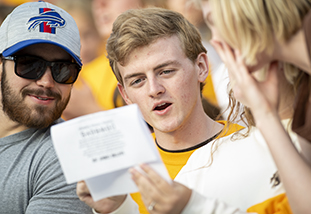 A male student reacting to a written message.