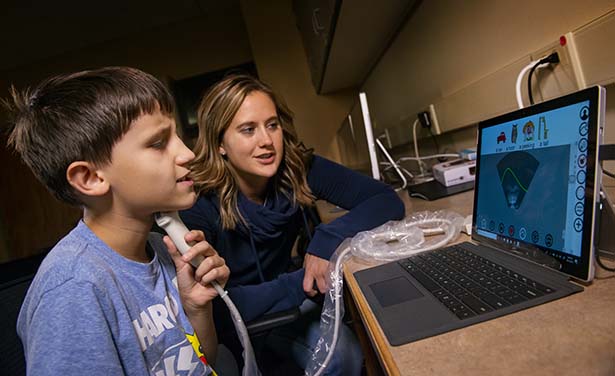 Speech Pathologist working with child.