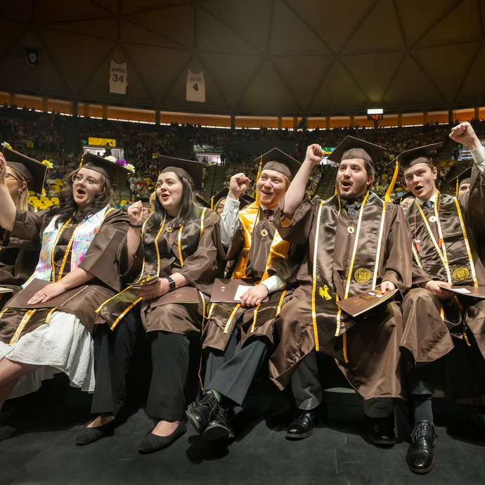 graduates cheering at commencement