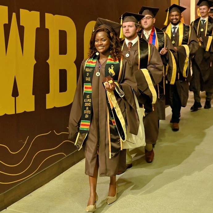 graduates walking at commencement