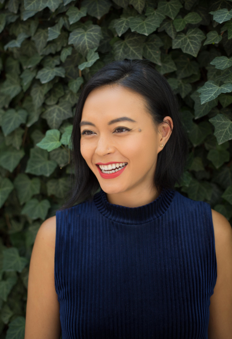 Smiling woman wearing a blue blouse.