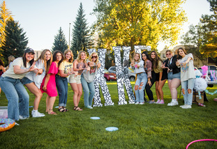 UW sorority members stand together at the Cowboy Carnival to promote joining their sorority
