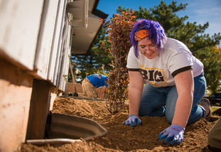 A UW student participates in some landscaping at the UW Big Event for community service