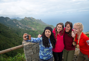 A group of UW students pose together for a picture at a scenic overlook