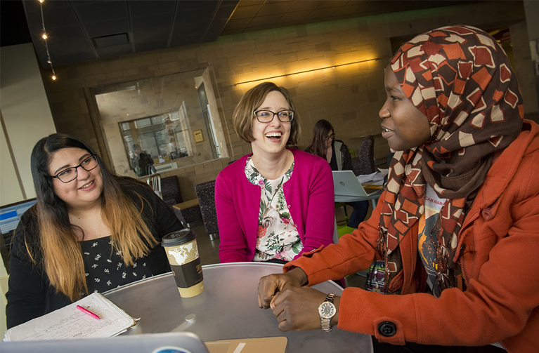 three women talking at table