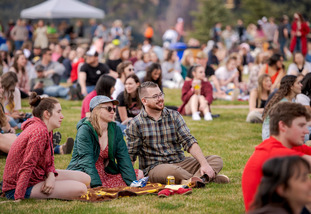 UW students and community members sit together outside for an event held on UW’s campus