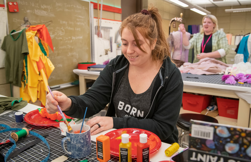 UW students participate in a student organization activity involving paint and fabric