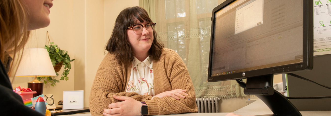 student and advisor looking at computer screen