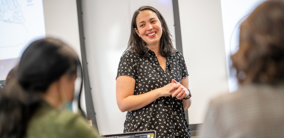 A UW faculty member smiles as they instruct their class and utilizes skills from the Ellbogen Center for Teaching and Learning.