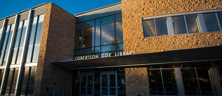 Front doors Coe Library: Our Mission