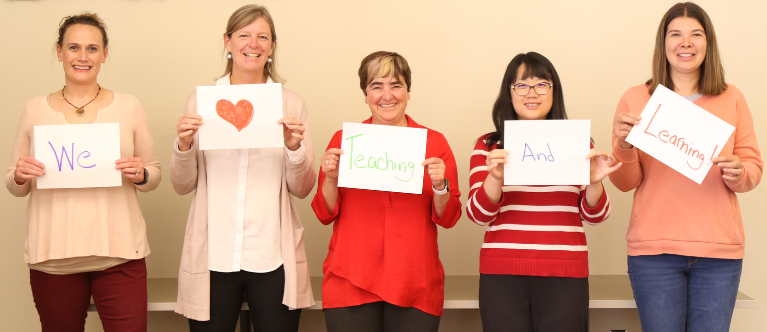 ECTL staff holding signs that say "we heart teaching and learning": Meet Our Staff