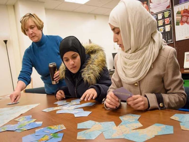 UW students and instructor working on activity at table with note cards