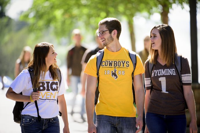 Three Students Walking to class wearing UW gear