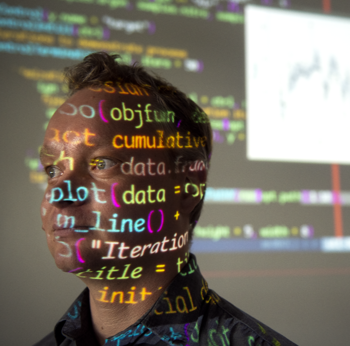 Lars Kotthoff with data projected onto his face and the background