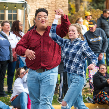 Two students dancing in parade