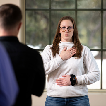 Female student with hand on heart