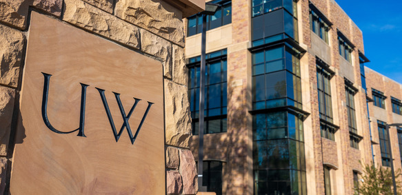 A sign reading “UW” stands prominently on the University of Wyoming campus.