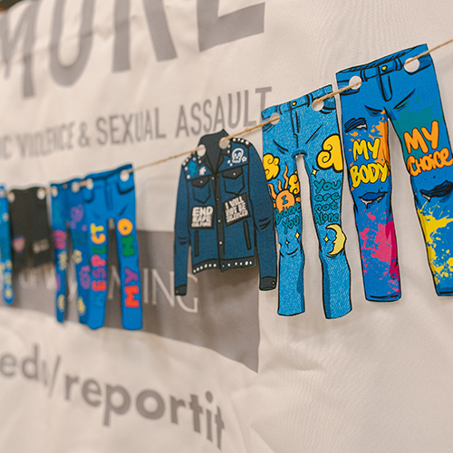 Denim clothing cut out of paper hangs on a clotheline