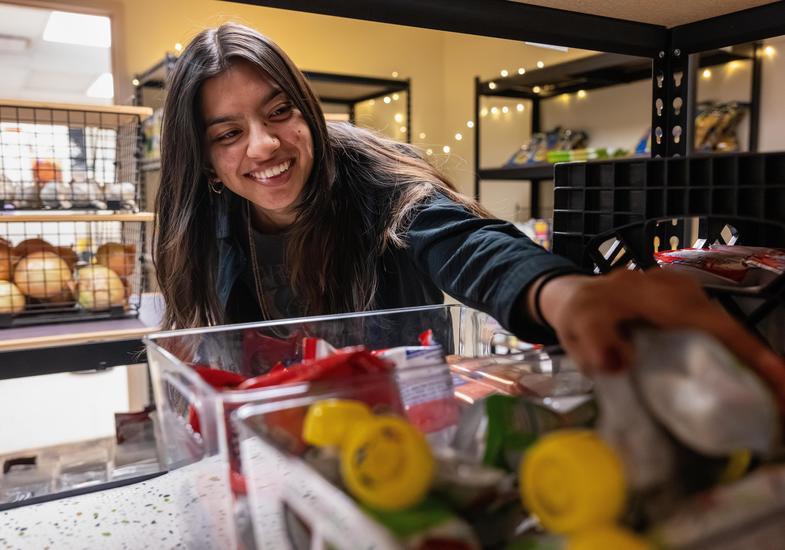 Student grabbing snacks at the food pantry