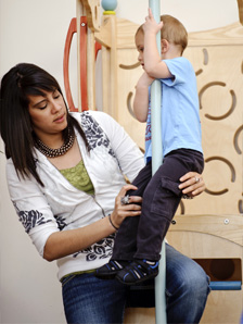 Student with Child on Play Firemen's Pole