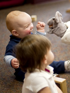 Child exited playing with puppet