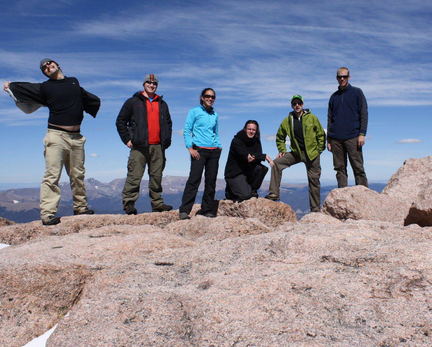 graduate students standing on a rock