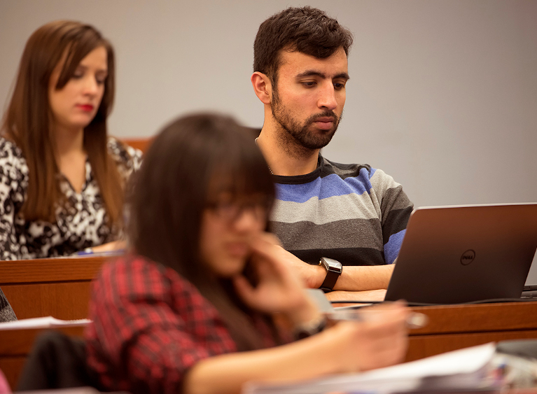 student using his computer in class