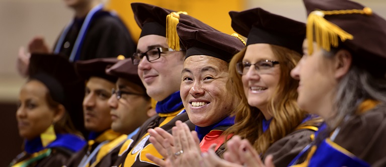 Students laugh and smile during commencement