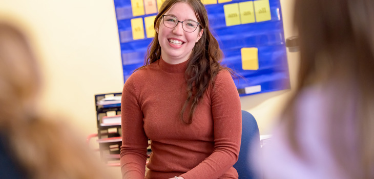 Education student smiling in front of her class