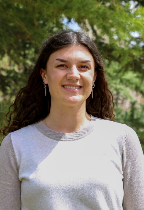 Woman (Lauren Hansen) in front of trees