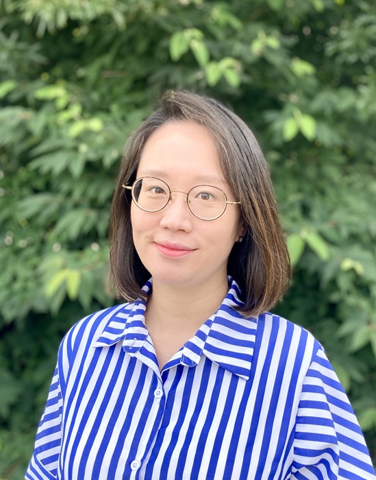 Dr. Min Jung Lee in a blue and white striped blouse