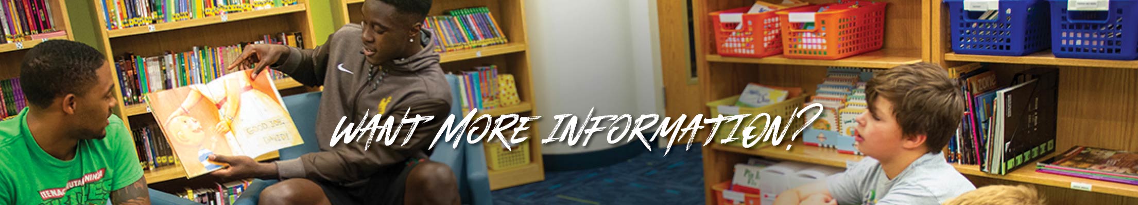 Want more information? - two student teachers read to some children.
