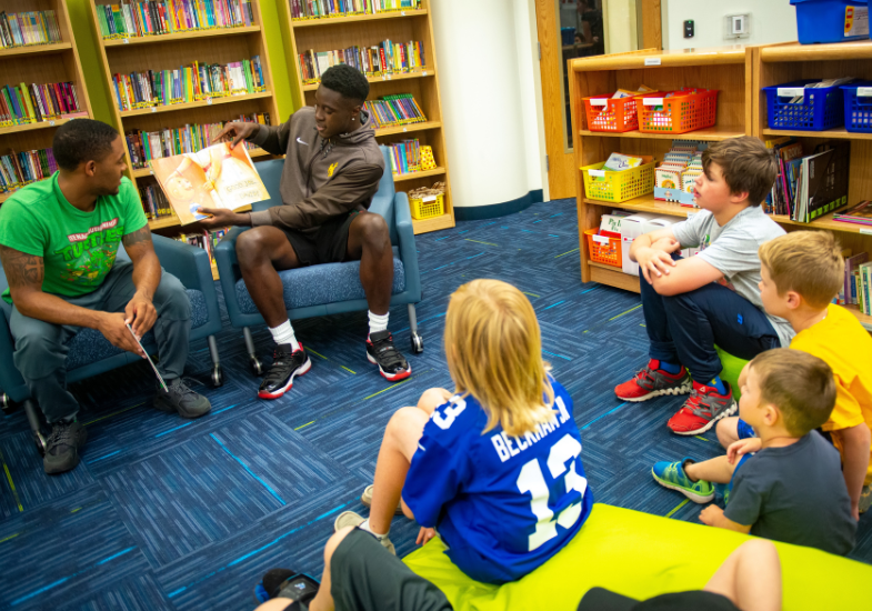 Seniors students helping juniors to read