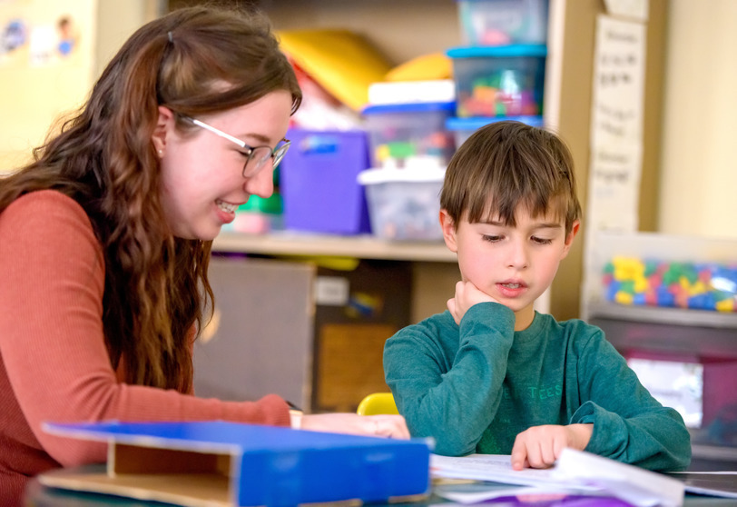student and teacher working together