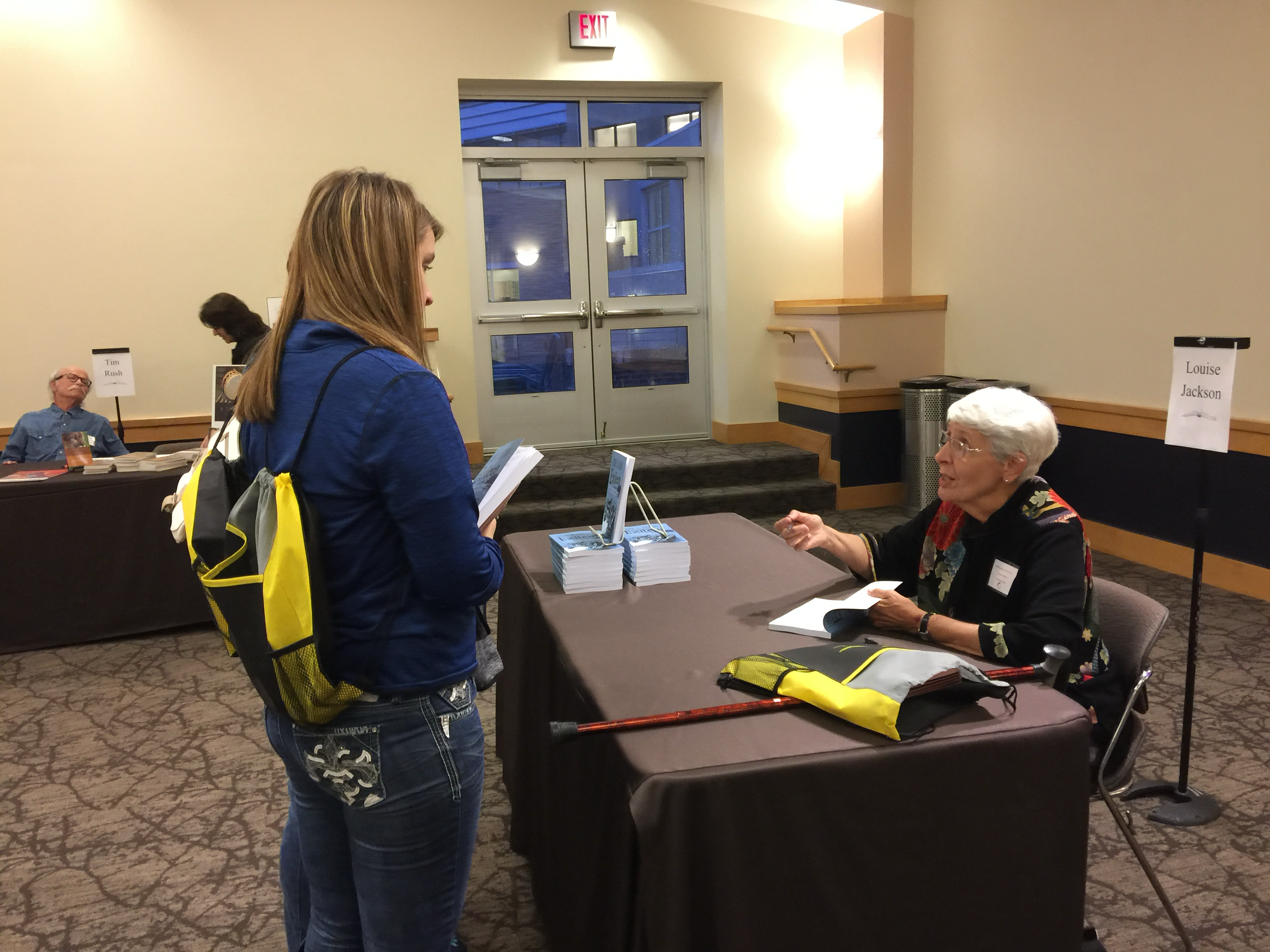 a woman talking to an author
