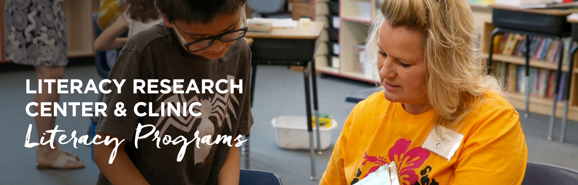 Teacher working with student with wording: Literacy Research Center & Clinic Literacy Programs