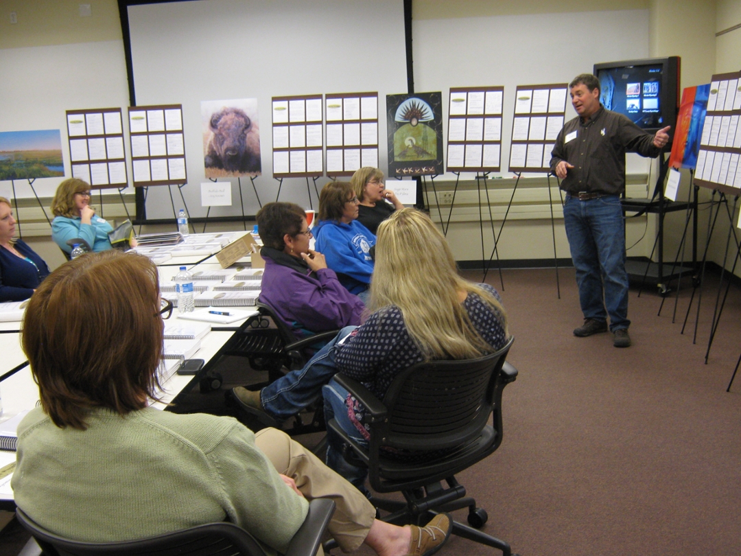 teacher explaining a chart to students in a classroom