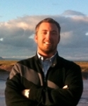 Dr. Mark Helmsing smiles by a lake