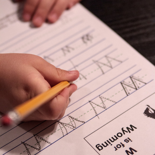 child writing w is for wyoming