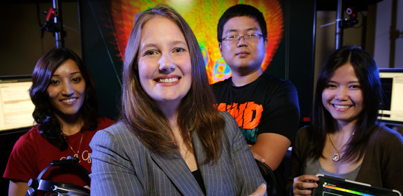 A group of electrical engineering and computer science students and faculty smile for a photo