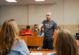 College student presenting to youth