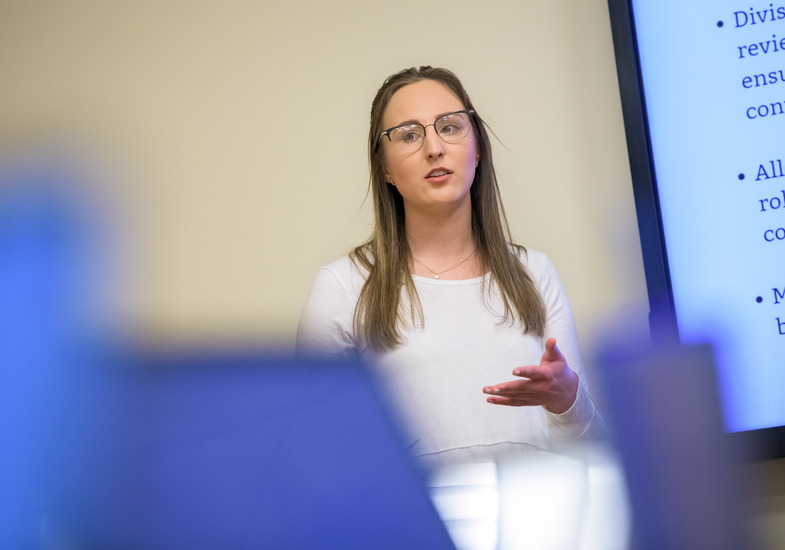 A student presents in front of the public