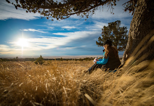 Student writing on the prairie