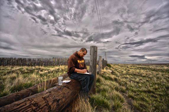 Student writing in a field