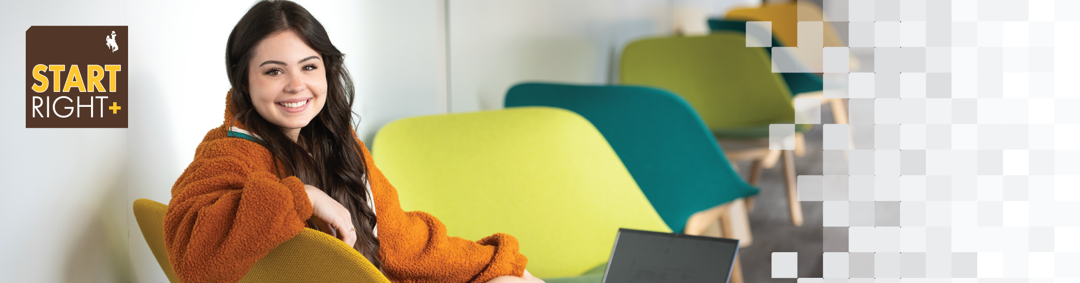 Female student sitting in a orange chair looking over her shoulder smiling at the camera with the StartRight+ tag logo in the top left corner of the image