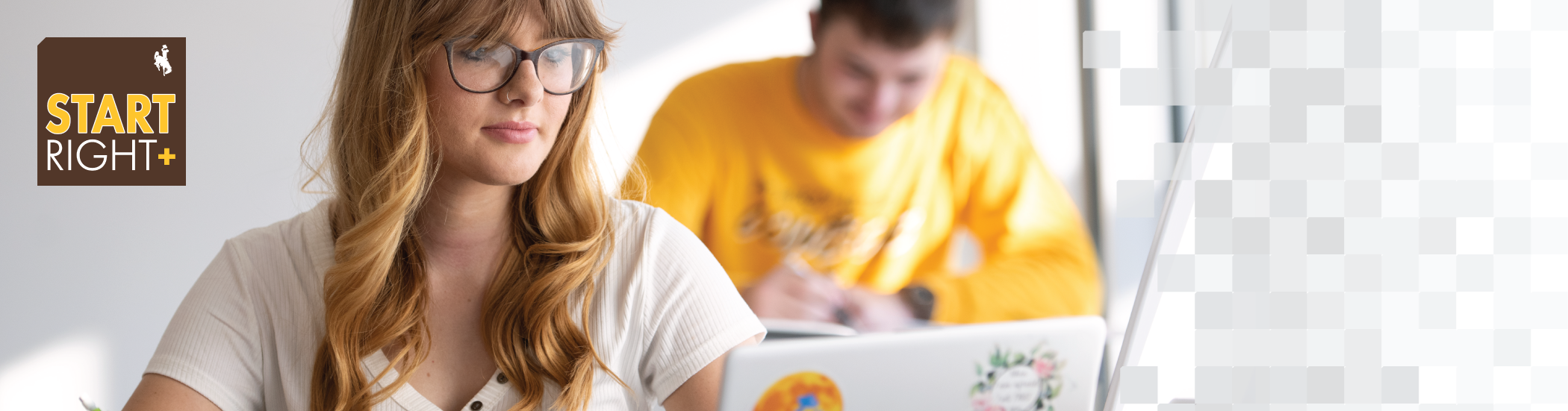 Female student in glasses working on her laptop with the StartRight+ tag logo in the top left corner